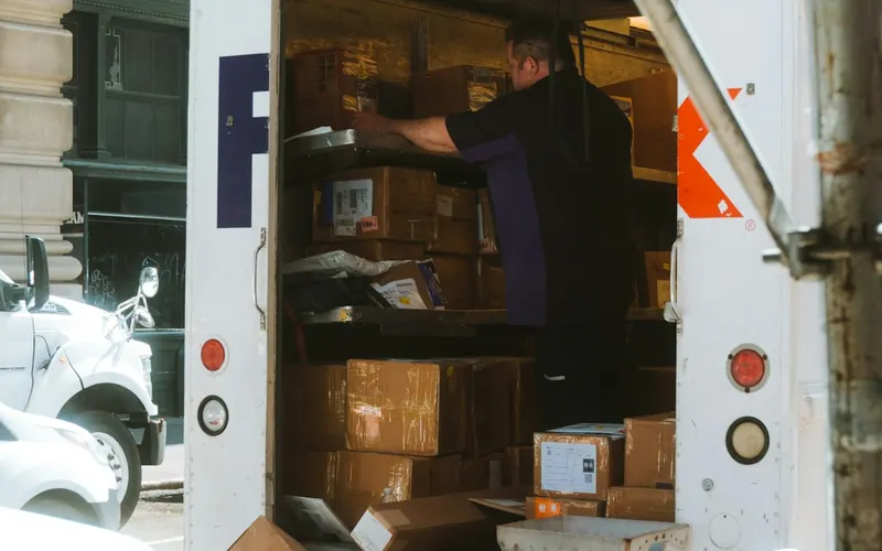 Movers loading boxes into the back of a truck